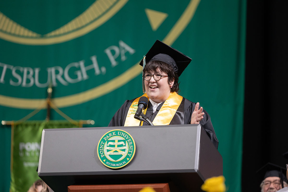 A graduate speaks at the podium