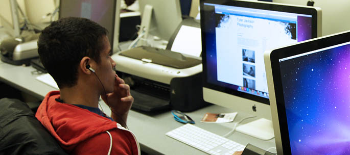 A School of Communication student works on a project in a computer lab in Academic Hall. Photo by Andrew Weier.