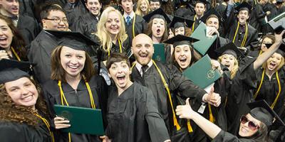 Undergraduate students at Point Park University shout and wave after participating in Commencement May 3, 2014 at the Consol Energy Center. | Photo by John Altdorfer