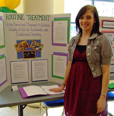 Senior Jenni Anderson with her thesis display during the Honors Program Celebration of Learning. | Photo by Rachel Norris