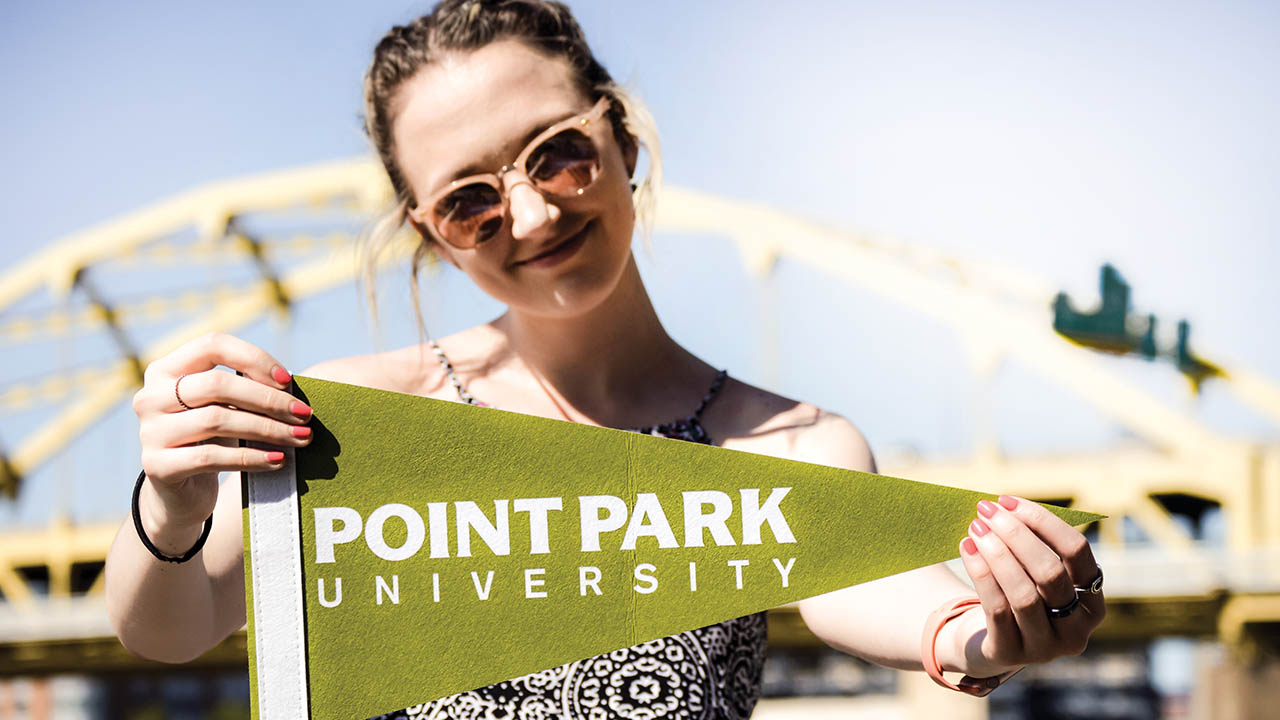 A student with a Point Park banner.