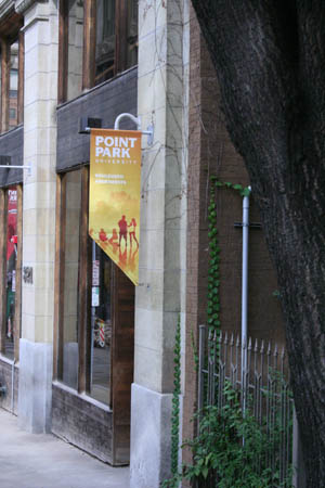 A colorful yellow banner marks the exterior of the Boulevard Apartments, on campus living for upperclassmen at Point Park University. 