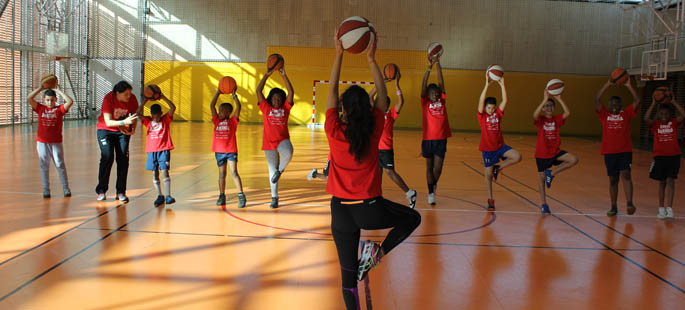 Pictured is Helena Knorr, Ph.D., teaching yoga to youth in the Euroleague Basketball's ONE TEAM program.