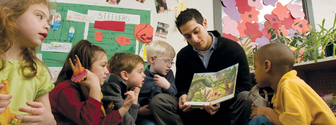 An education student reads to young children.