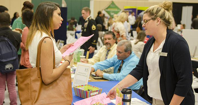Sports, arts and entertainment management senior Kayla Velez talks with an employer during the annual Internship and Job Fair at Point Park University. | Photo by Christopher Rolinson