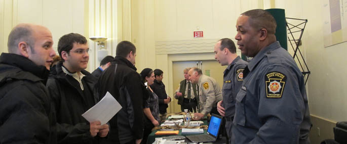 Pictured is a student talking with an employer at the 2013 Law Enforcement Career Day at Point Park.