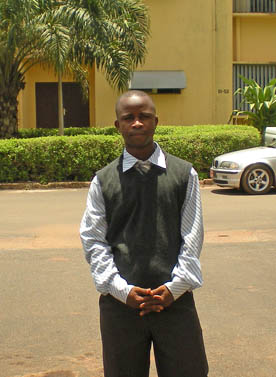MBA graduate Alphonse Tounkara outside his workplace in Guinea, West Africa. 