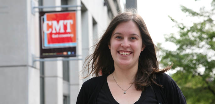 Amanda Hertzog, a multimedia student, stands outside CMT headquarters, where she did her summer internship. | Photo by Brian Tipton