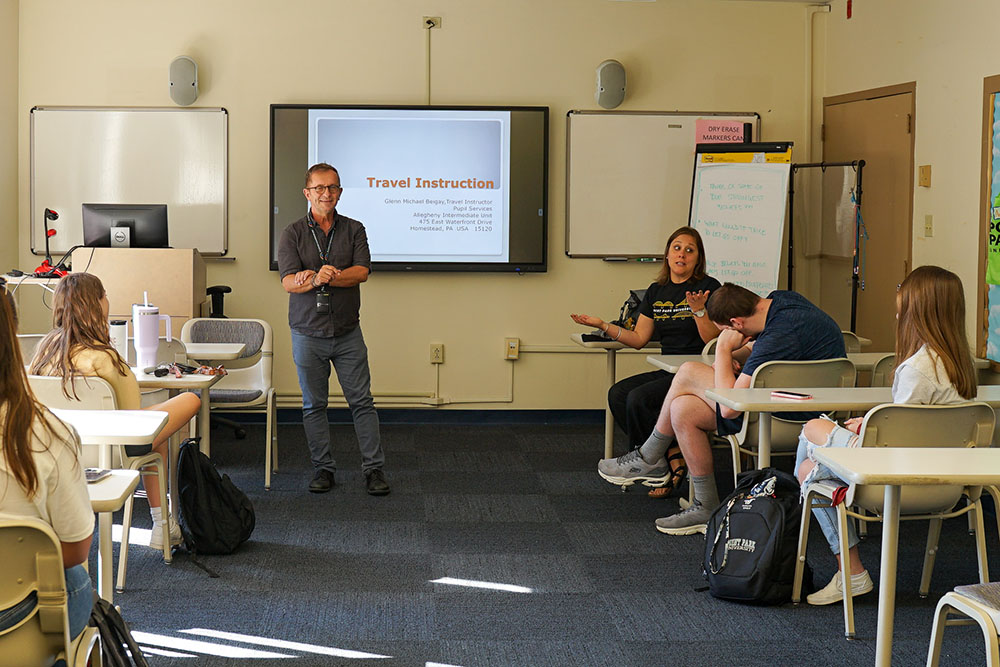 Pictured are Michael Beigay, travel instructor for the Allegheny Intermediate Unit, and Kristen Misutka, Ph.D., assistant professor of education, speaking to Point Park students in a classroom. Photo courtesy of the Allegheny Intermediate Unit's Special Education and Pupil Services Division.