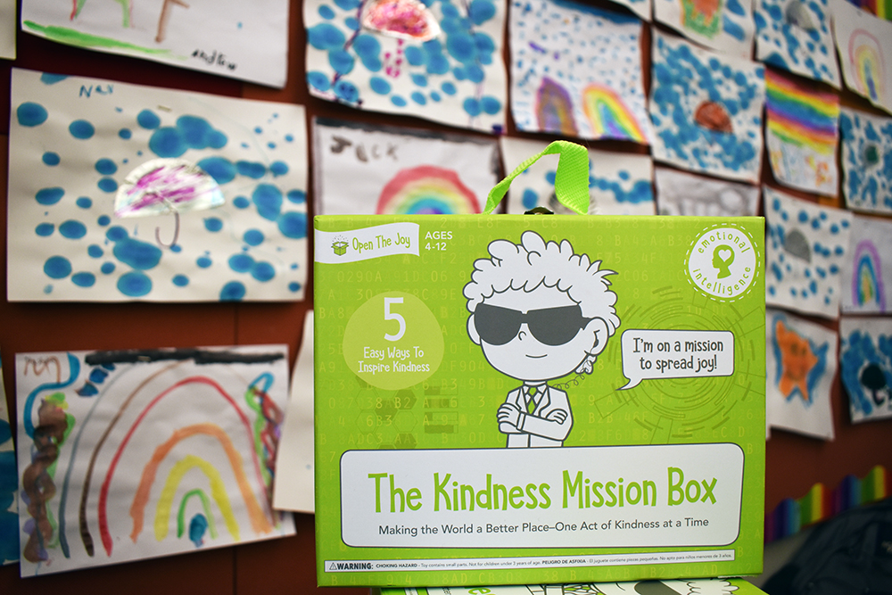 Pictured is a green "Kindness Mission" box from Open the Joy. Photo by Nicole Chynoweth.
