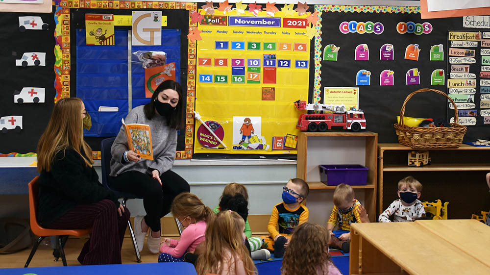 Point Park University students read a story to children at Wee Care Children's Center in Heidelberg, Pa. 