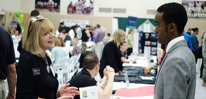 A student meets an employer at the annual Internship and Job Fair in the Student Center. Photo | Chris Rolinson