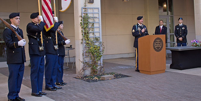 An ROTC color guard stands watch as Staff Sgt. Conrad Slyder addresses a Point Park gathering on Veterans Day 2014. | Photo by Victoria Mikula