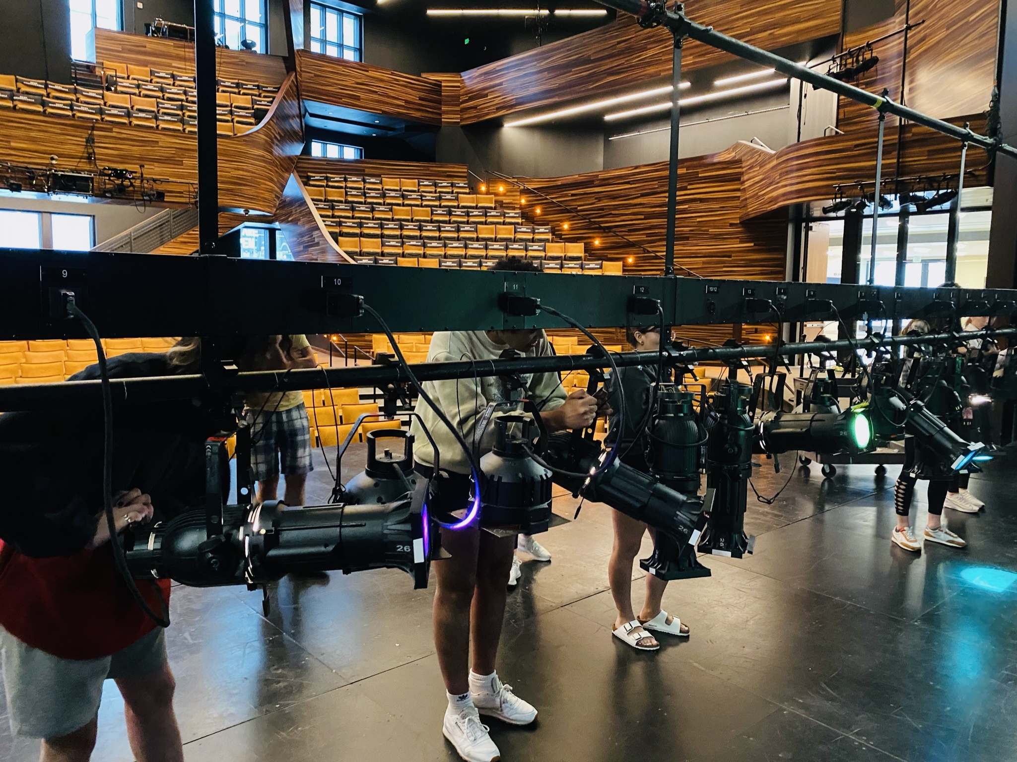 Pictured are students working on the lighting grid in the PNC Theatre. Photo by Nick Koehler. 