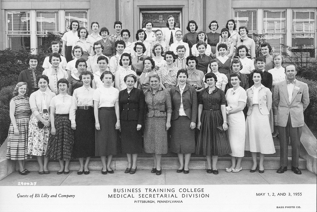 A group of women on stairs in front of a building