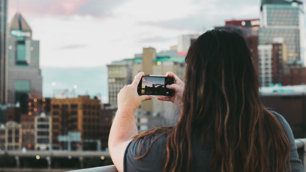 Student taking photo of city