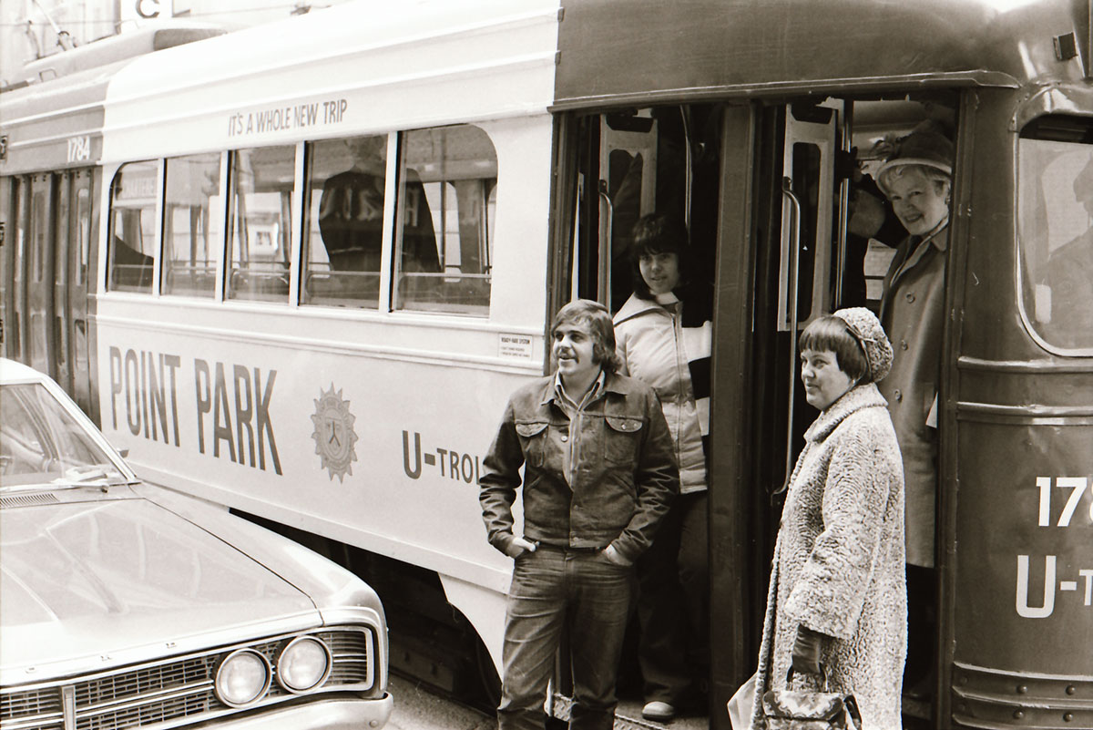 People stand near a bus