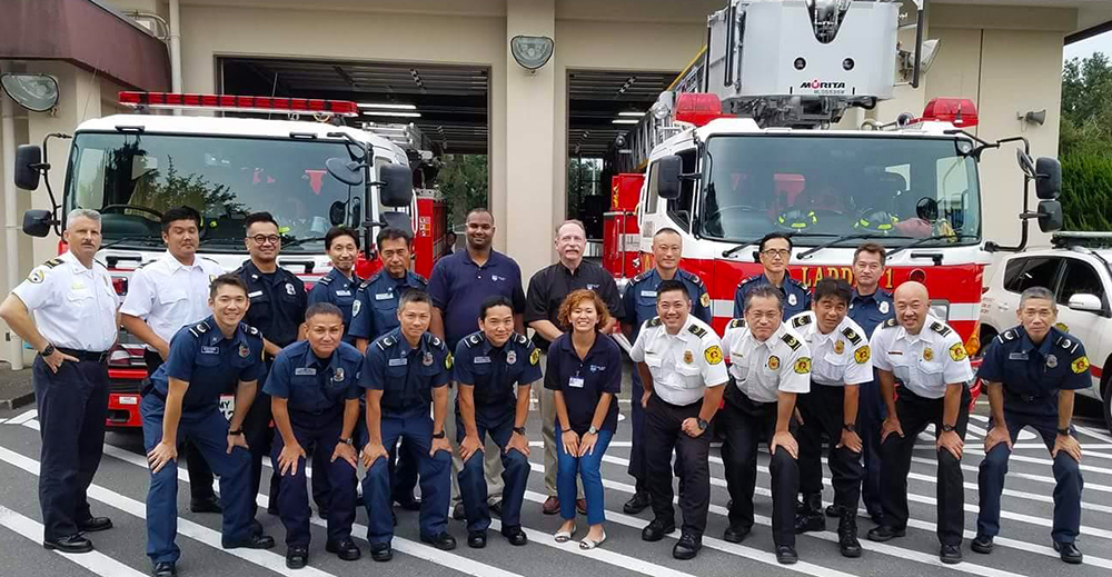 Pictured is Robert Skertich with firefighters in Japan. Photo submitted by Skertich.