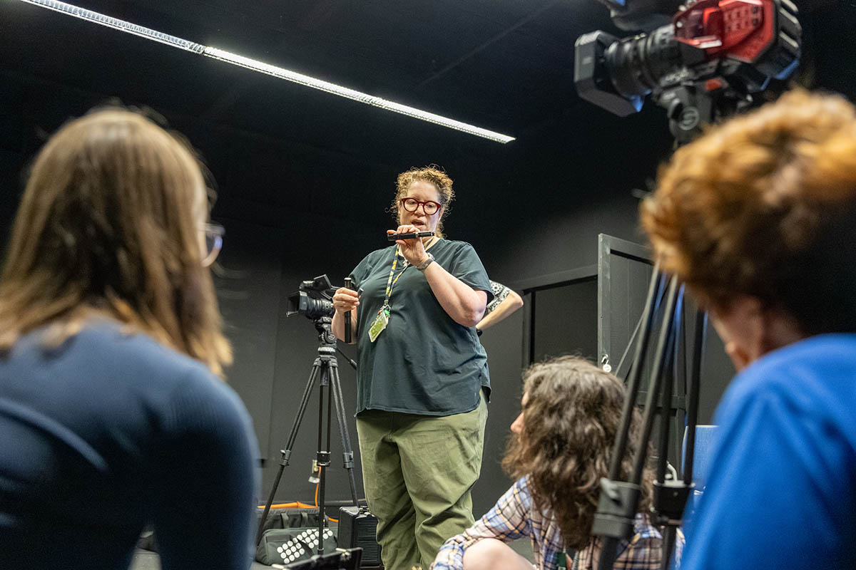 Associate Professor Kelly Donnellan teaches students how to use a camera during Film Intensive. 
