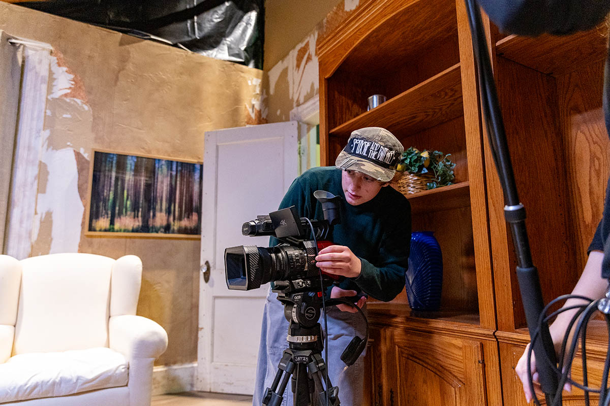 A student on a set during Film Intensive.
