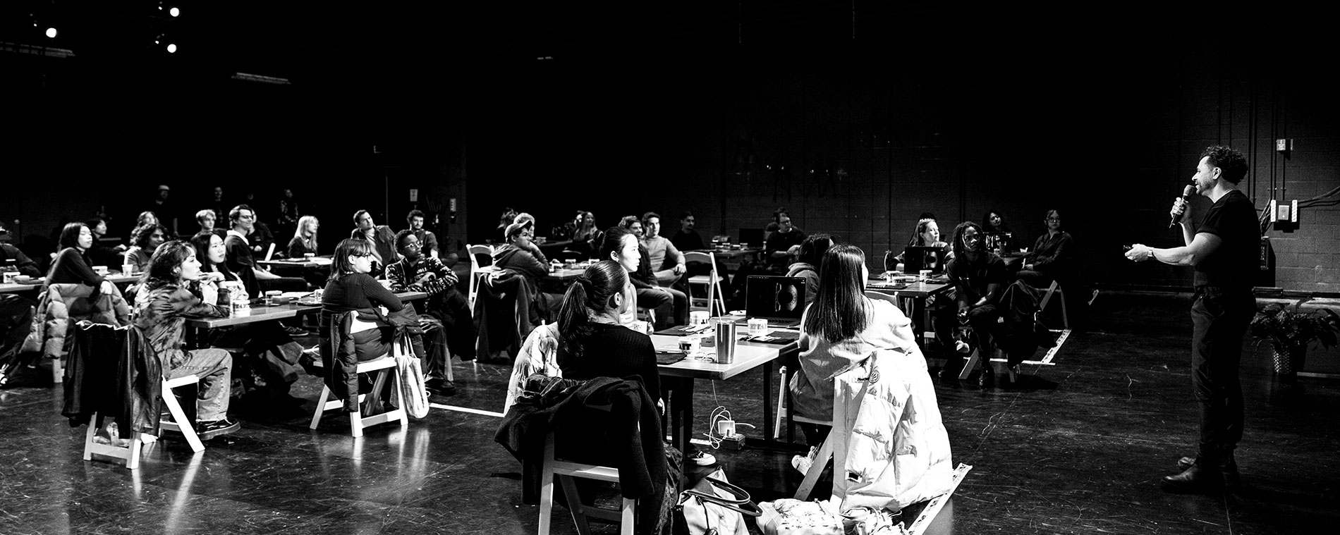 A man leads a workshop of students in the Highmark Theatre.
