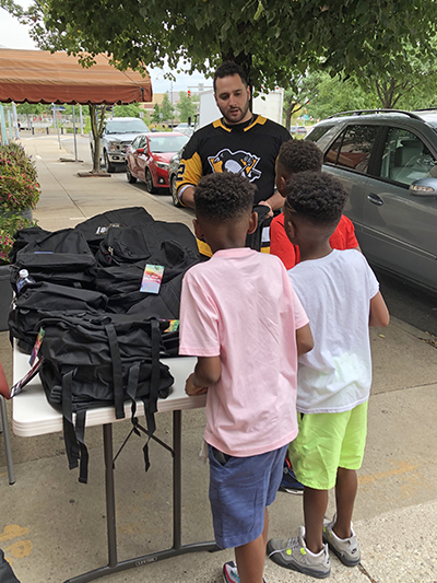 Pictured is education alumnus Spencer Marnich with kids at his Get Ready for School event.