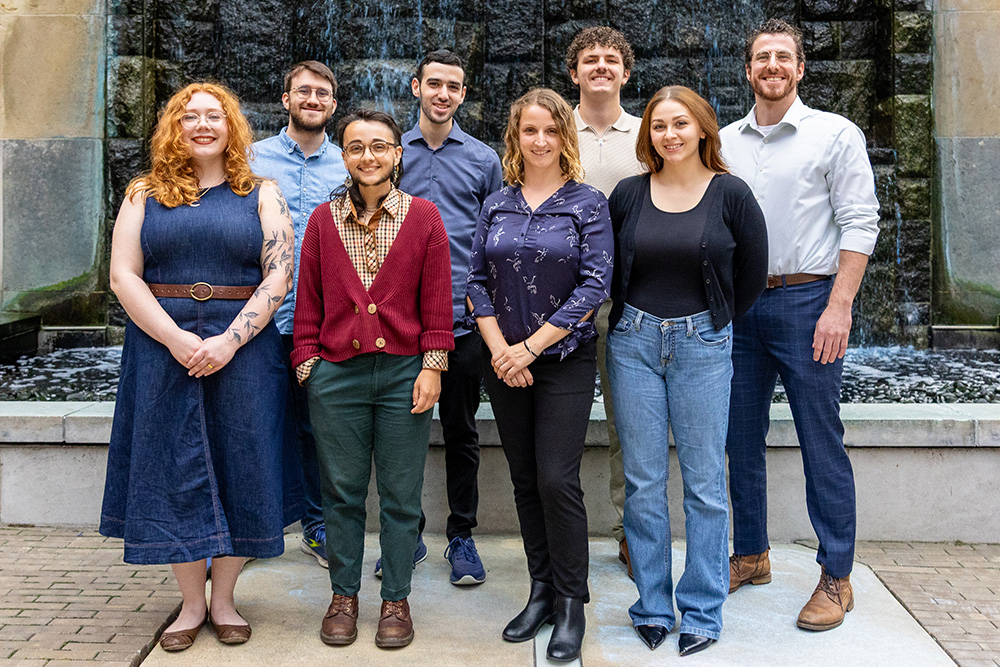 Students from the 2025 cohort of Point Park University's psychology doctoral program stand in Village Park near the waterfall. Pictured, from left to right and back to front, are Dean Robbins, Yehudah Polter, Samson Brown, Caleb Herrin, Vivian Kinter, Ansel Bloom, Melissa Malaspino and Alyssa Durocher. The photo was taken by Paul Koontz.