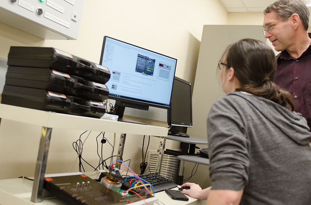 Pictured is Donald Keller teaching a student in a lab. Photo by Chris Rolinson.