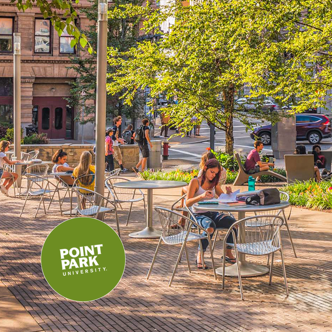Students seated in Village Park