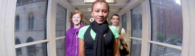 Portrait of three Point Park students on the skywalk connecting Lawrence and Academic Halls. 