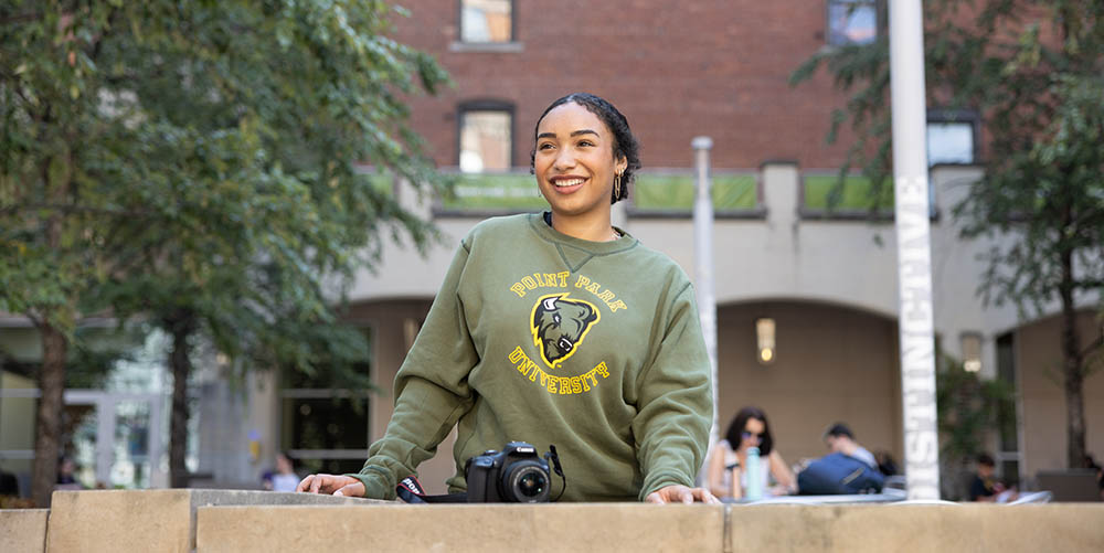 Pictured is a female student in Village Park. Photo | Chancelor Humphrey