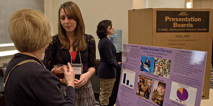Honors student and psychology major Christina Wisniewski explains her poster on Animal Assisted Therapy and its use in treatment of children with autism or Asperger’s syndrome while presenting at the Northeast Regional Honors Council Conference in Philadelphia in April 2013.