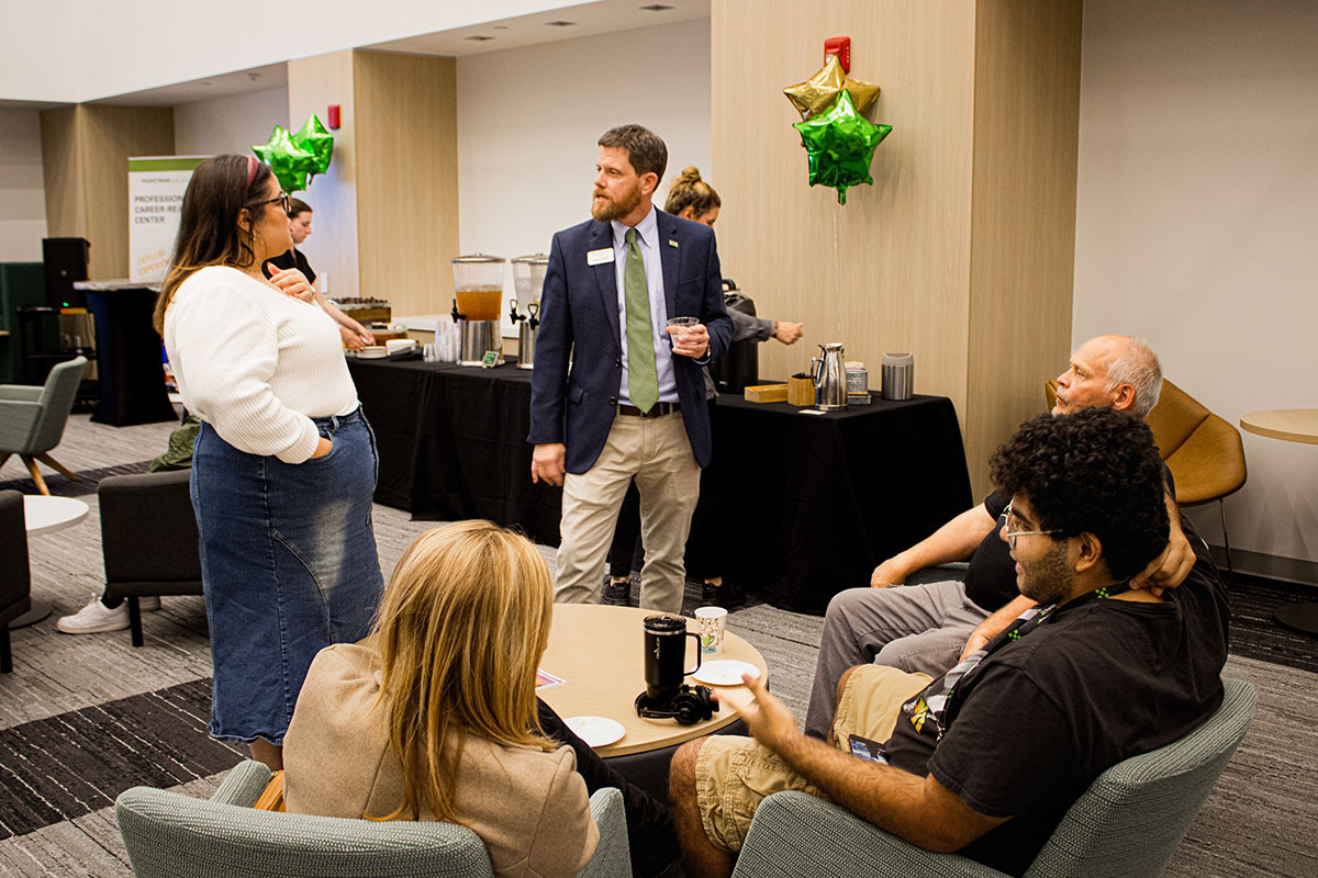 People at a reception in the Professional Career Readiness Center.