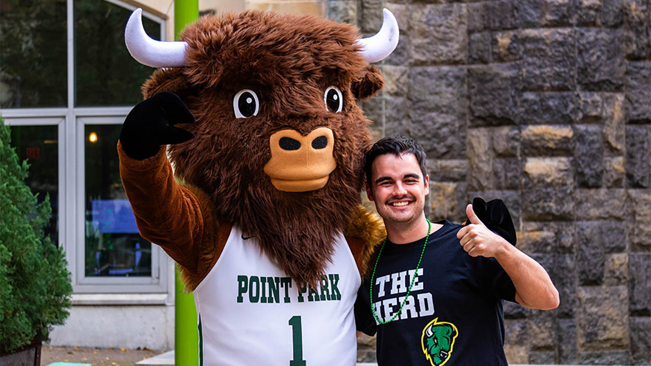 A photo of the bison and a Point Park student. 
