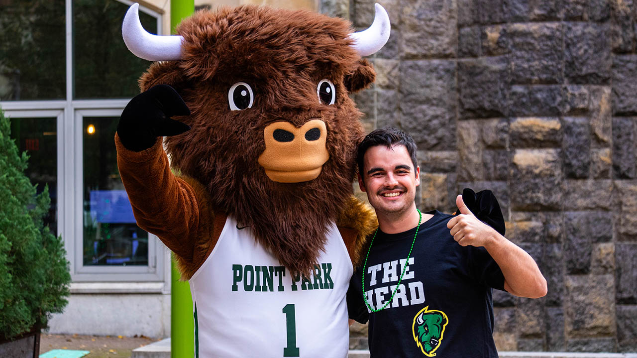 The bison with a Point Park student in Village Park during a Pep Rally. 