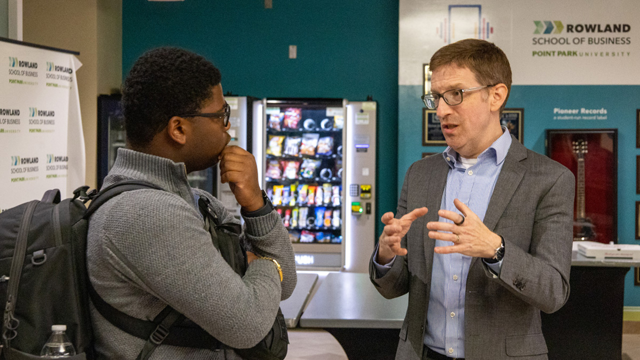 Geoff Anisman, deputy assistant secretary for Preservation and Global Platforms at the U.S. State Department's Bureau of Educational and Cultural Affairs, meets with a Point Park University student in the Michael P. Pitterich Sales and Innovation Center.