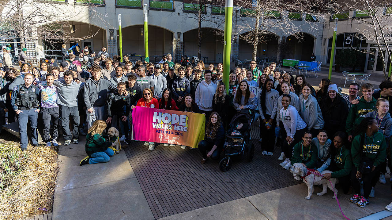 Participants in the 2025 Out of the Darkness Walk pose in Village Park, where the walk begins and ends.