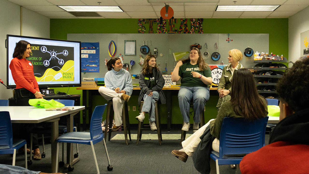 Students and faculty speak to prospective students and families at March Admitted Students Day.