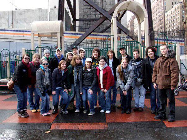 The group poses for a New York City park they shoveled: Back row: Amelia Hogan, Brittany Johndrow, Julie Gongware, Christopher Dettore, Alicia Lyons, John Sfarnas, Zoe Sadler, Helen Fallon, Mack Frantz, Surrae Shotts and Justin Platek. Front row: Adelyn Biedenbach, Mary Eklund, Flora Strange, Allison Wynands, Anna Rhodes and Faith Cotter. | Photo by Allison Wynands