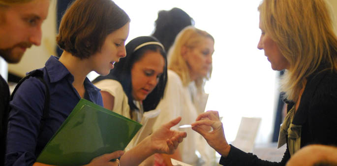 A Point Park student accepts a business card from a employer recruiter at the annual Internship Fair in Lawrence Hall. | Photo by Christopher Rolinson