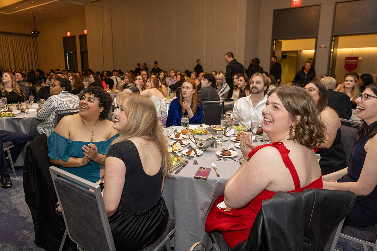 Wide angle photo of a room of full tables.