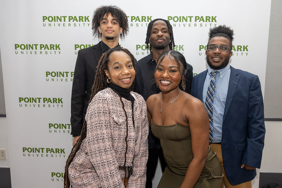 Students pose in front of a Point Park background.