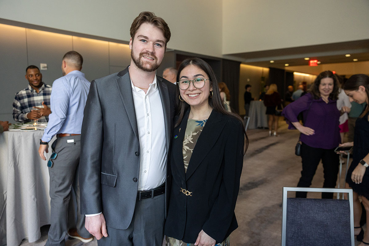 A male and female student pose for a photo.