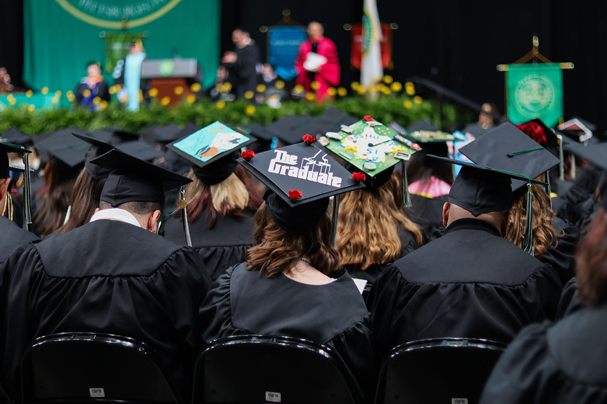 The back of graduates with a focus on the decorated graduation cap