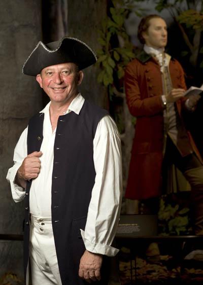 Assistant Professor Michael Botta, with George Washington in the background, at the Senator John Heinz History Center in May 2010 to celebrate the opening of the Fort Pitt Museum. | Photo by Martha Rial