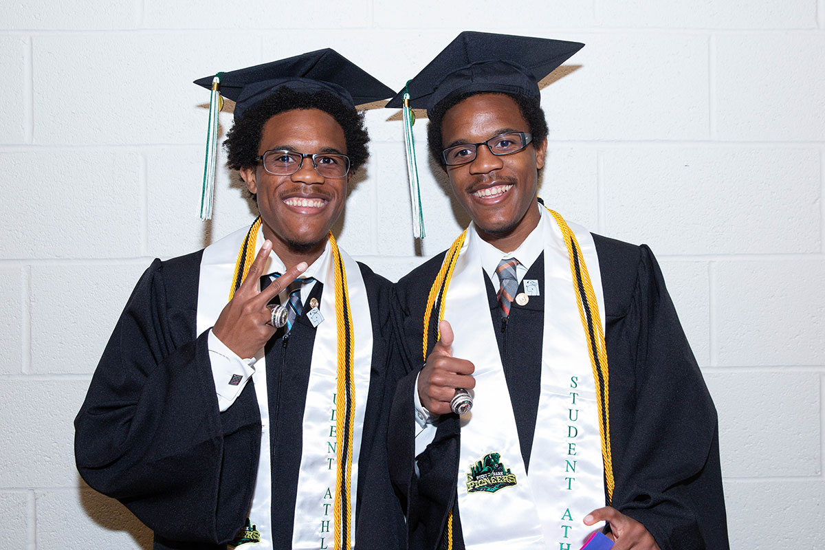 Two male twins in cap and gown