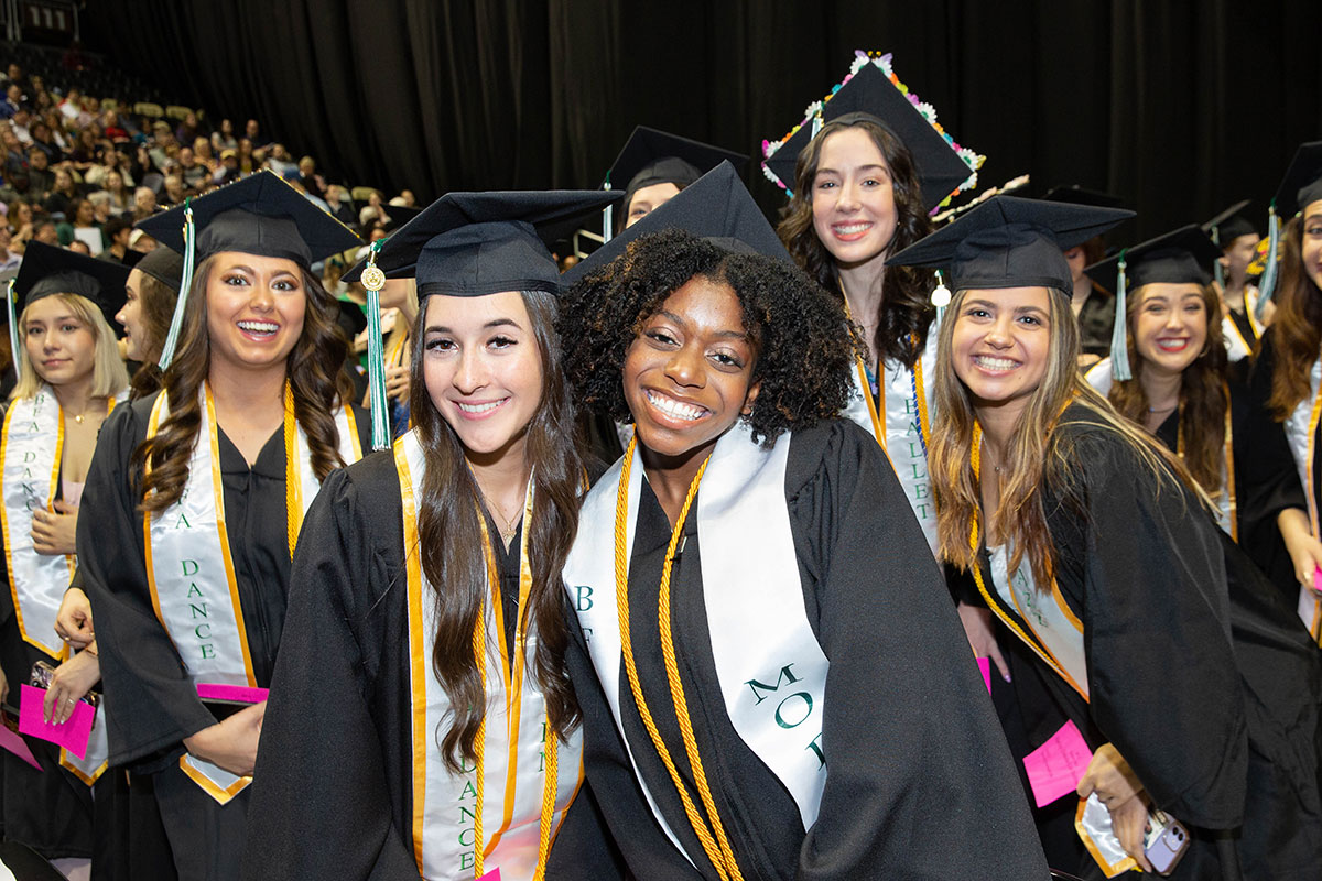 A group of female graduates pose for the camer