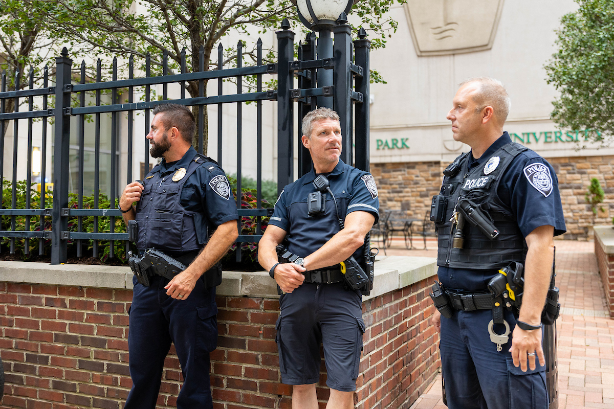 Three police offers stand in Alumni park