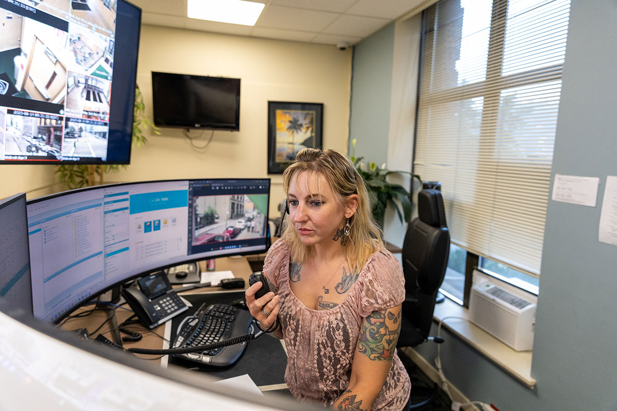 A female dispatcher talks into a radio.