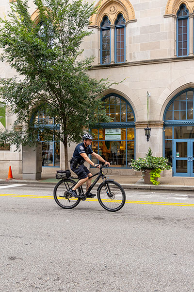 A police officer rides a bike on Wood Street.